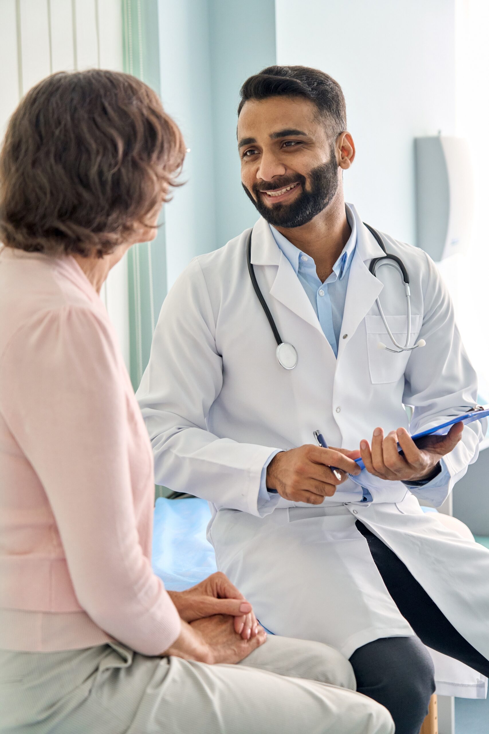Vertical,Shot,Of,Young,Happy,Cheerful,Indian,Medical,Worker,Therapist
